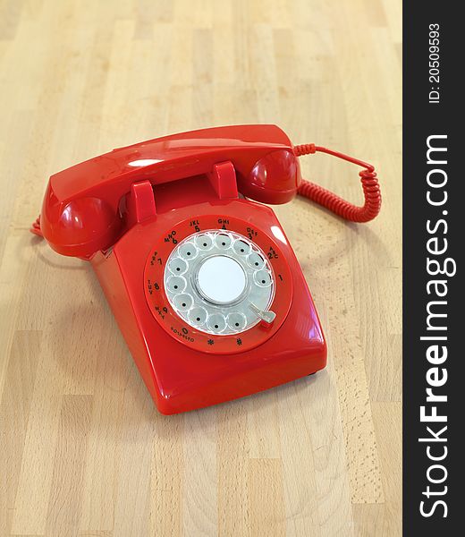 A vintage rotary telephone on a desk