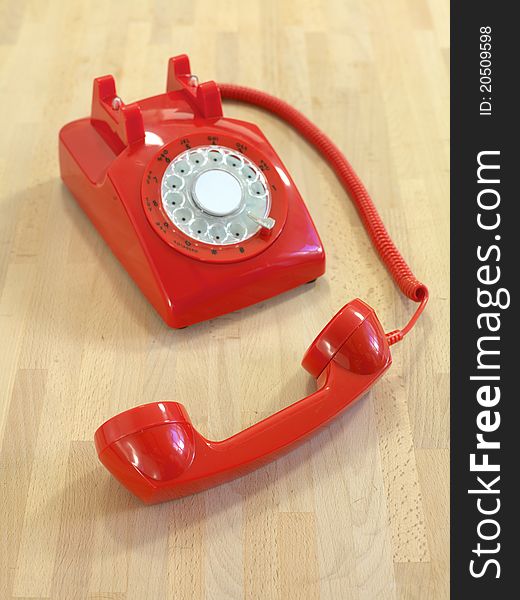 A vintage rotary telephone on a desk