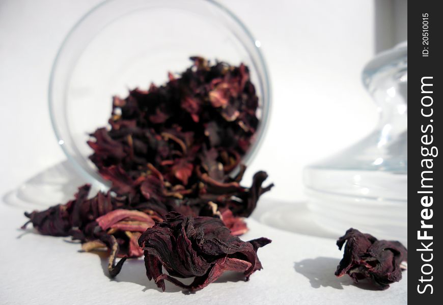 Leaves of the red tea in the opened glassy jar.