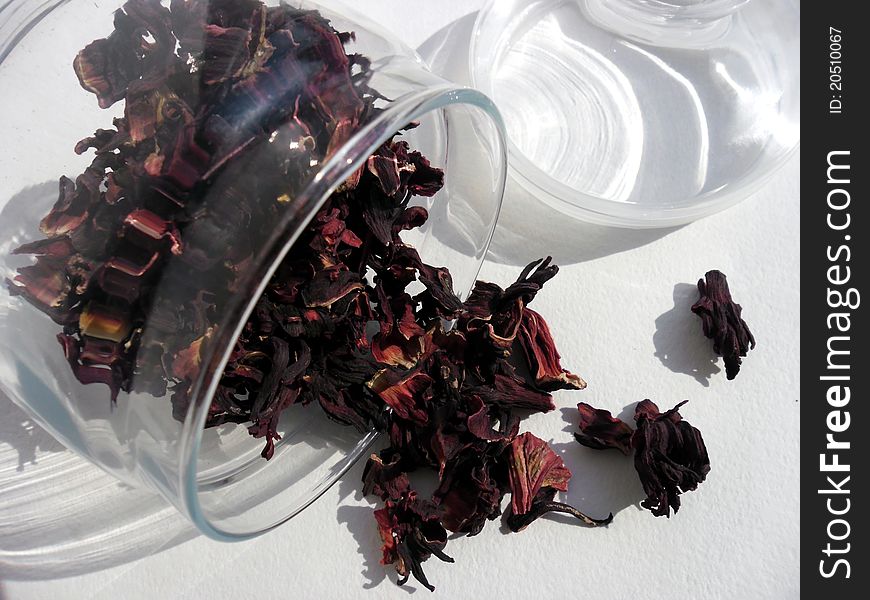 Red tea leaves in the opened glassy jar. Red tea leaves in the opened glassy jar.