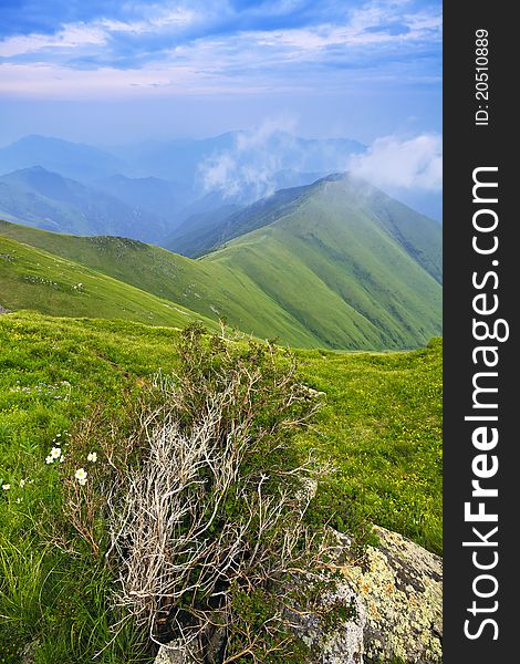 Mountain landscape with clouds and fog.