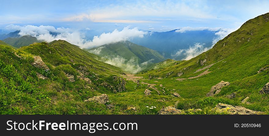 Mountain landscape with clouds and fog.