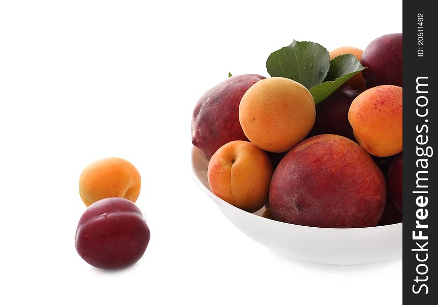 Fresh peaches, plums and apricots  in white bowl. Fresh peaches, plums and apricots  in white bowl