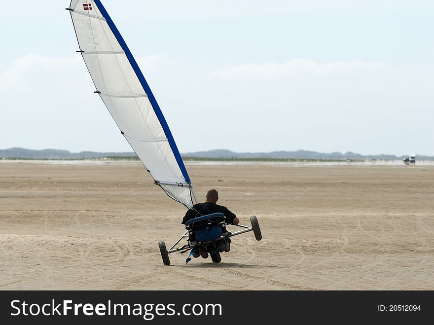 Land sailing on two wheels on the beach in summer on Roemoe in Denmark. Land sailing on two wheels on the beach in summer on Roemoe in Denmark