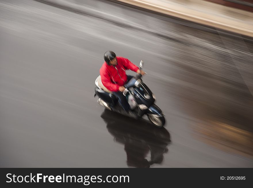 A moto scooter air panning with a long exposure time