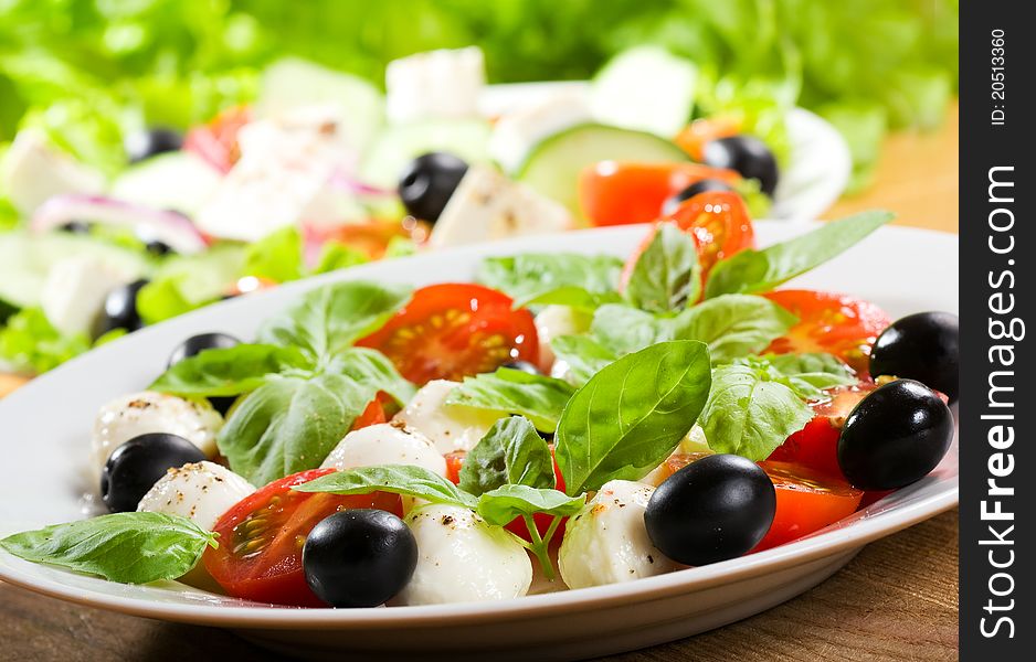 Salad with mozzarella and tomatoes. Salad with mozzarella and tomatoes