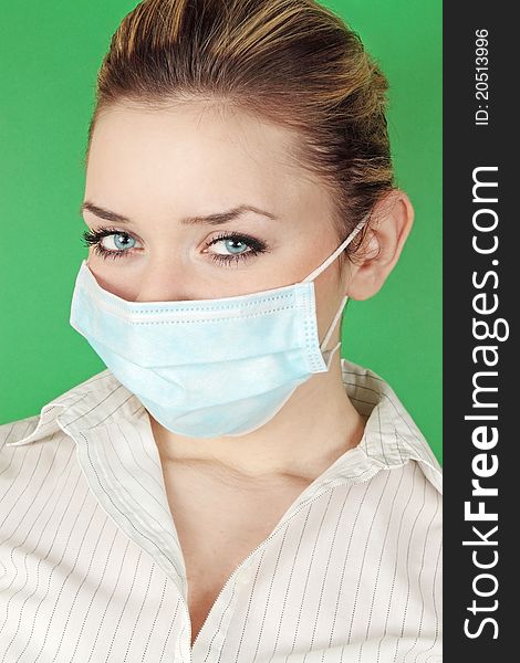 Woman in the medical bandage against the green background