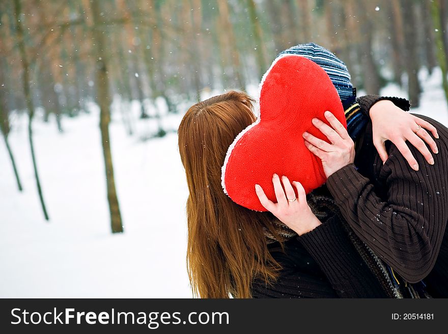 Couple with heart kissing, winter