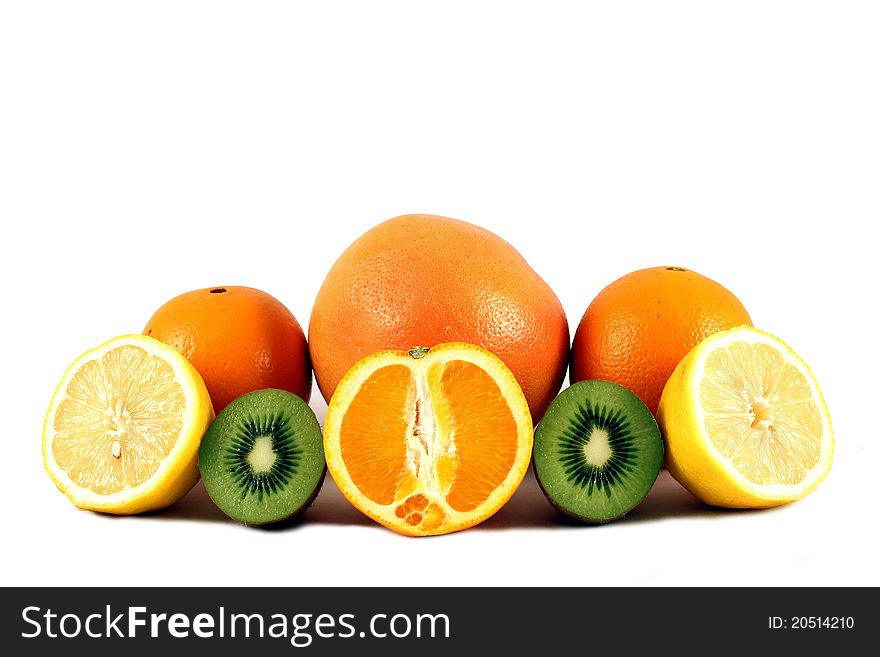 A citrus fruit plate consisting of some lemons, kiwis, and oranges