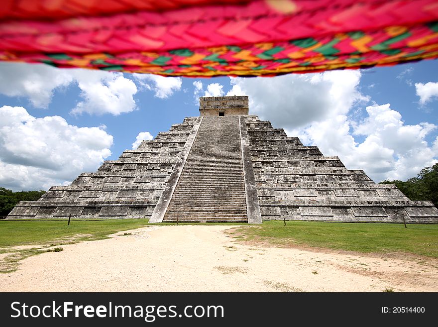 Dominating the main platform of ChichÃ©n is the Temple of Kukulkan (the Maya name for Quetzalcoatl), often referred to as El Castillo (the castle). This step pyramid, slightly more than 29 meters high, consists of a series of square terraces, each slightly more than 2.5 meters high, with a 6-meter-high temple at the top. The sides of the pyramid are approximately 55.3 meters at the base and rise at an angle of 53 degrees, although that varies slightly for each side. The four faces of the pyramid have protruding stairways that rise at a 45-degree angle. At the base of the balustrades of the northern staircase are carved heads of a serpent. Dominating the main platform of ChichÃ©n is the Temple of Kukulkan (the Maya name for Quetzalcoatl), often referred to as El Castillo (the castle). This step pyramid, slightly more than 29 meters high, consists of a series of square terraces, each slightly more than 2.5 meters high, with a 6-meter-high temple at the top. The sides of the pyramid are approximately 55.3 meters at the base and rise at an angle of 53 degrees, although that varies slightly for each side. The four faces of the pyramid have protruding stairways that rise at a 45-degree angle. At the base of the balustrades of the northern staircase are carved heads of a serpent.