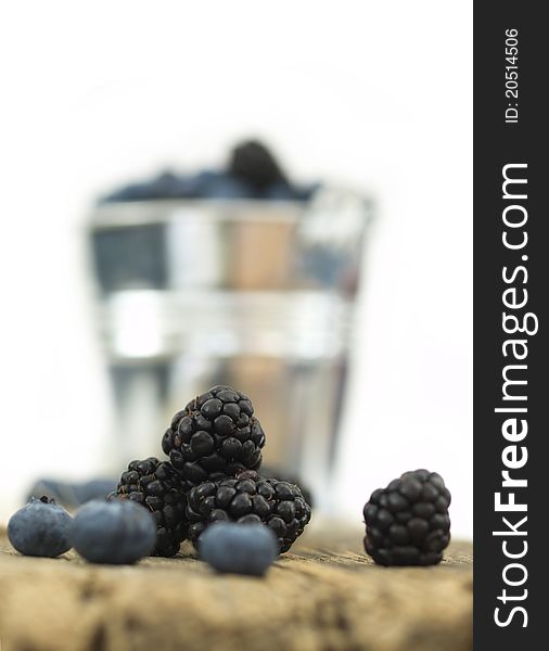 Blueberries and blackberries on the wooden background. Blueberries and blackberries on the wooden background