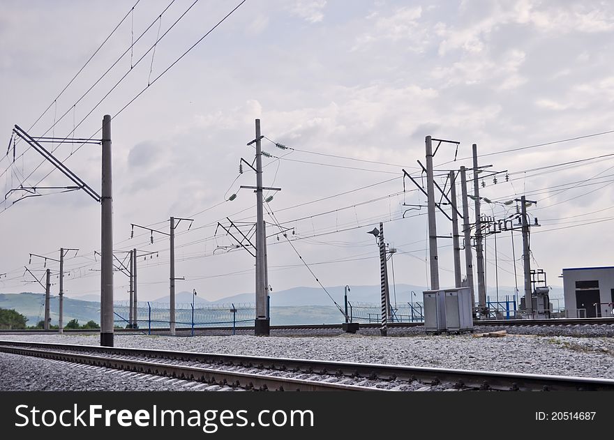 Railroad track, embankment, and power poles