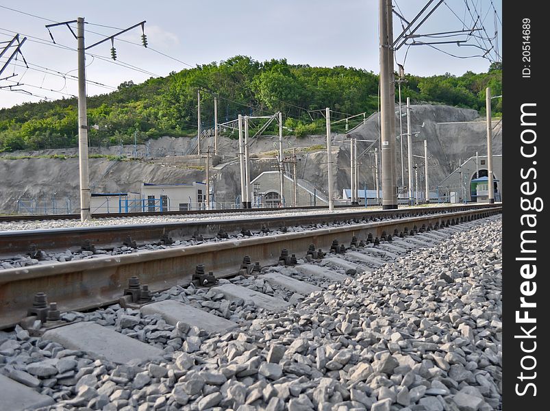 Railroad track, embankment, and power poles