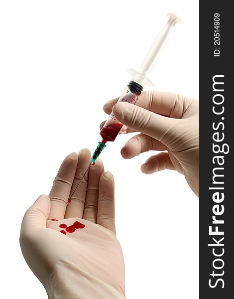 Syringe with blood in gloved hands