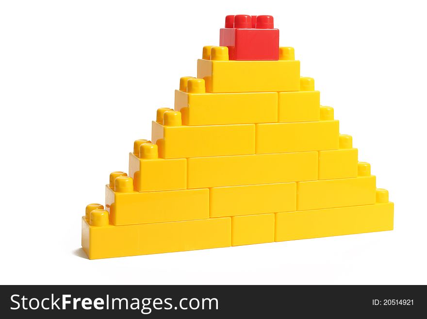 Plastic constructor pyramide with red top isolated on white with clipping path.