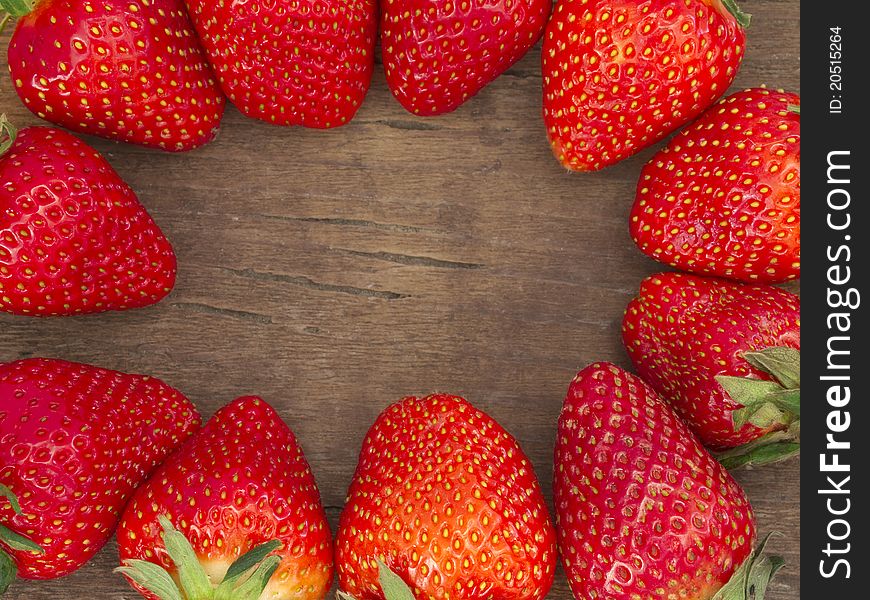 Fresh fruit making border on the wooden background. Fresh fruit making border on the wooden background