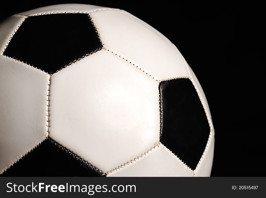 Closeup of football ball on black