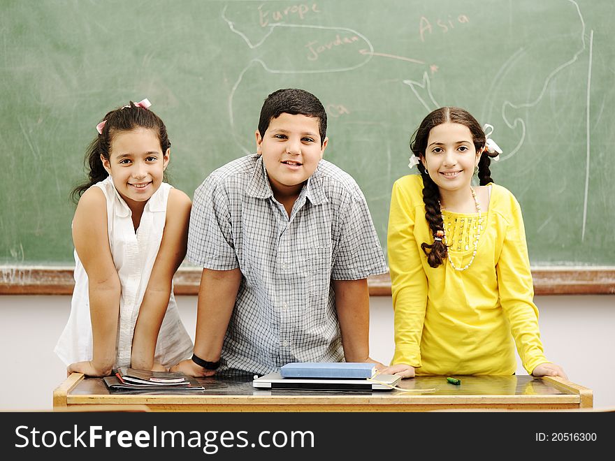 Three happy children in classroom. Three happy children in classroom