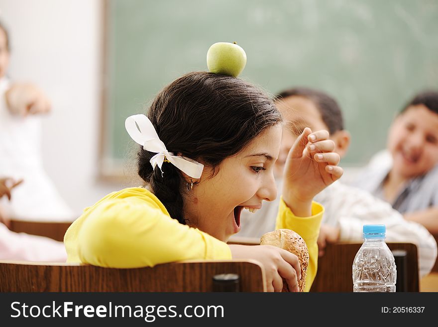 Children playing in classroom, happiness and togetherness with learning in education