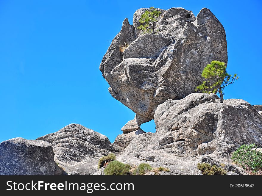 Enormous rock on top of a rock cavity formed