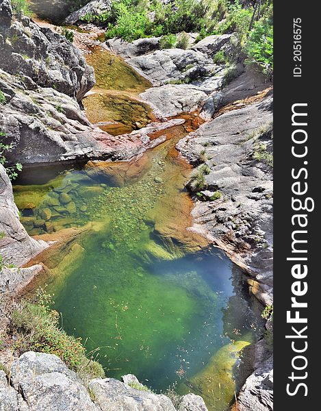 a natural swimming pool with water emerald