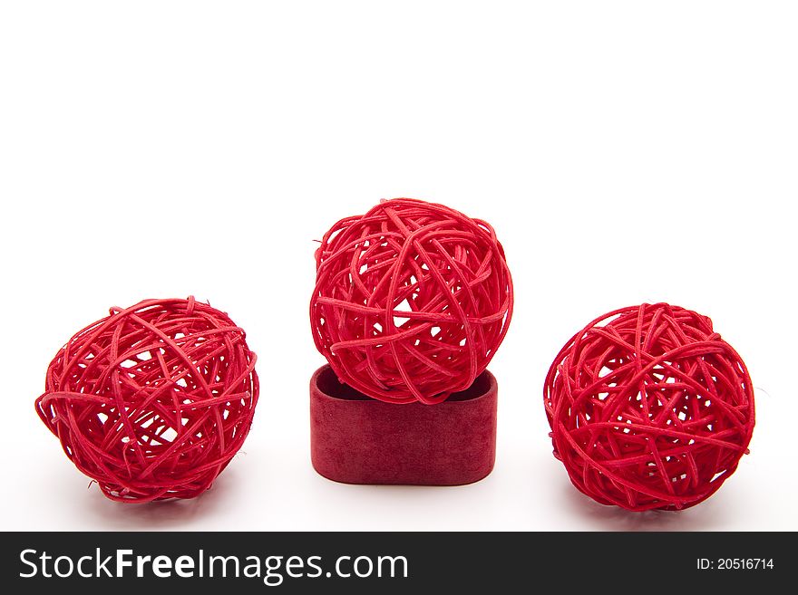 Red straw balls bound onto white background