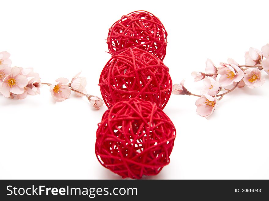 Red straw balls bound onto white background