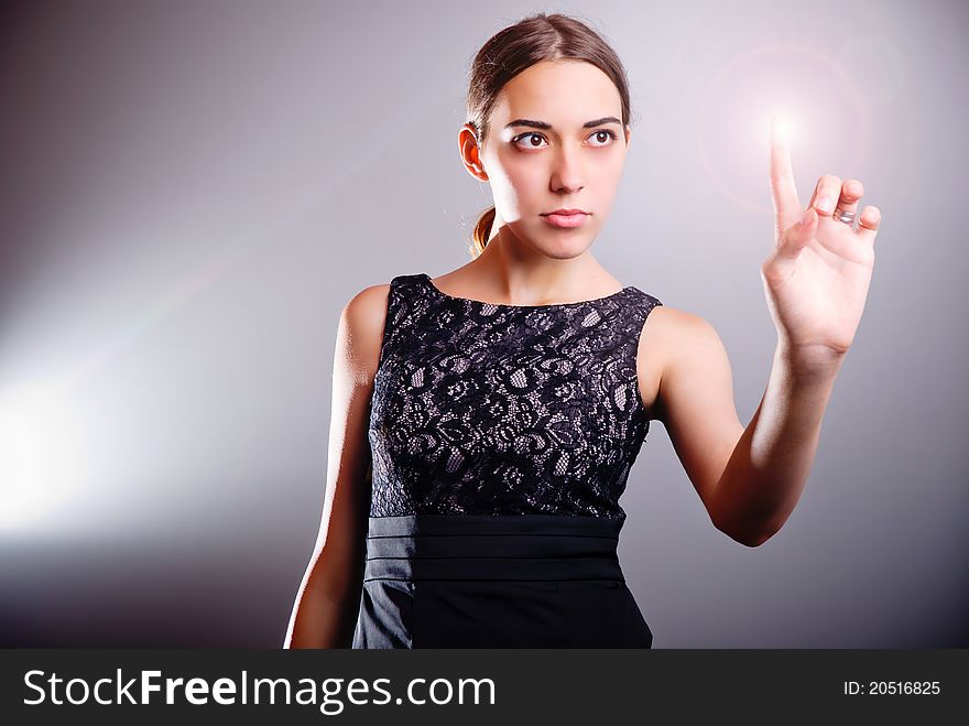 Attractive woman touching the energy ball in virtual future