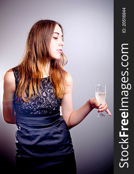 Young beautiful woman drinks wine from wine glass