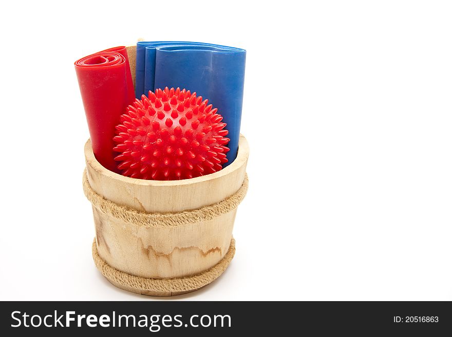 Massage ball and gymnastic ribbon in the wood receptacle