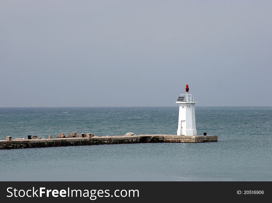 White light house in a port in Novigrad, Istria, Croatia. White light house in a port in Novigrad, Istria, Croatia