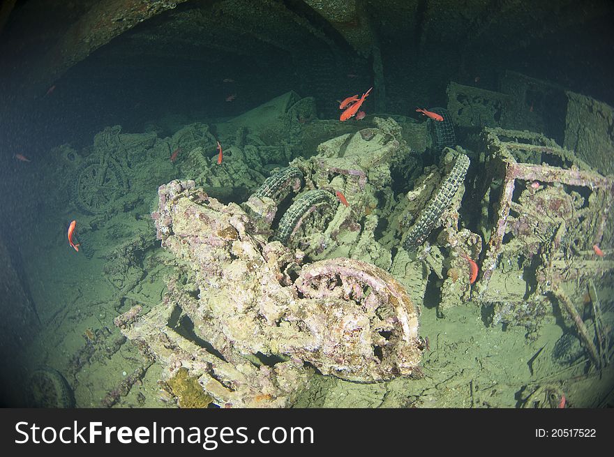 Old motorbikes inside the hold of a large shipwreck from world war 2. Old motorbikes inside the hold of a large shipwreck from world war 2