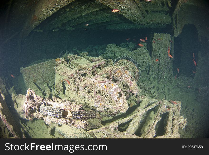 Old motorbikes inside the hold of a large shipwreck from world war 2. Old motorbikes inside the hold of a large shipwreck from world war 2