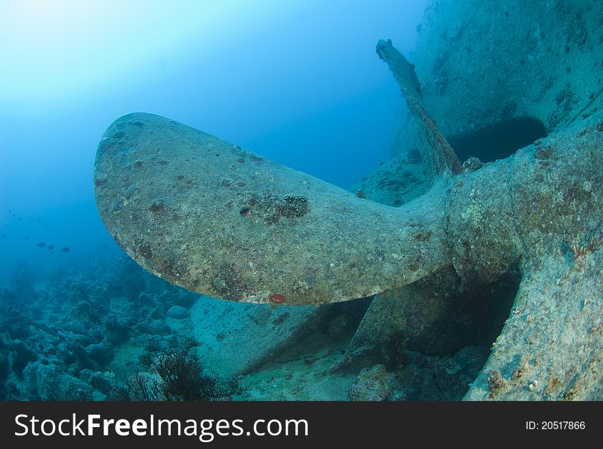 Huge propeller under the water on a large shipwreck. Huge propeller under the water on a large shipwreck