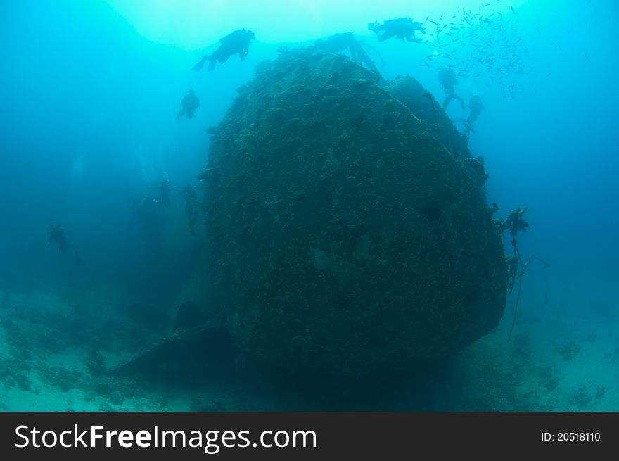 Divers Exploring A Large Shipwreck