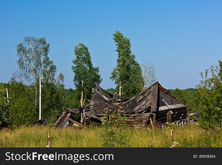 The ruins of an old house on the background of nature