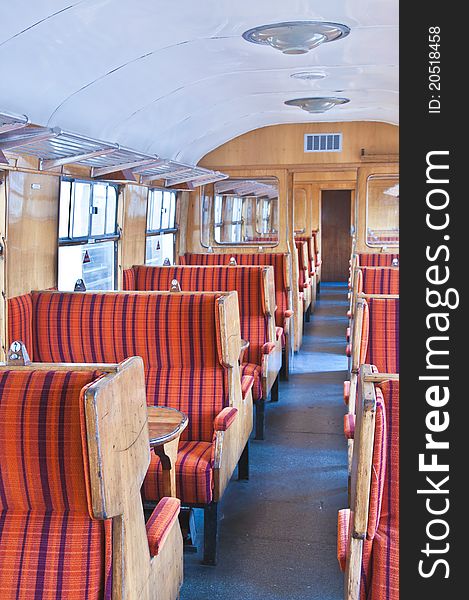 Old railway carriage in red striped seats