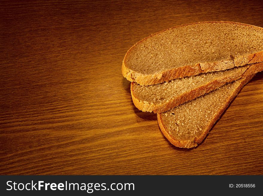 Sliced bread on wooden background