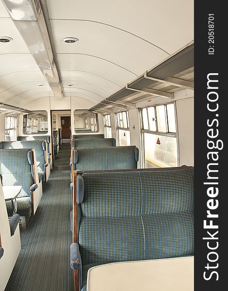 Old railway passenger carriage with green patterned seats. Old railway passenger carriage with green patterned seats