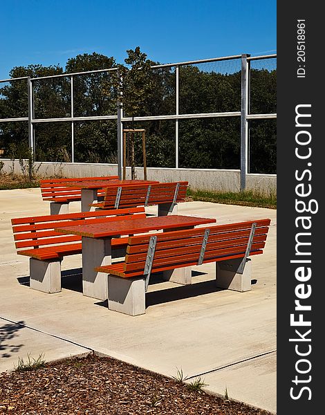 Resting place with benches and tables under blue sky. Resting place with benches and tables under blue sky.