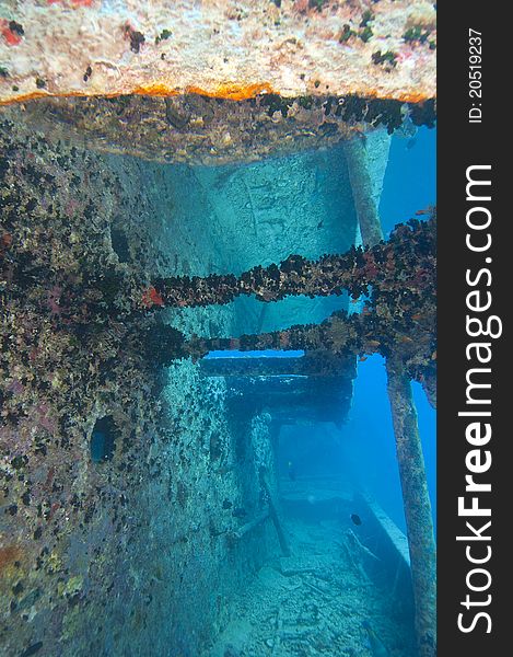 Companionway down the side of a large shipwreck with reflection in an airpocket above. Companionway down the side of a large shipwreck with reflection in an airpocket above