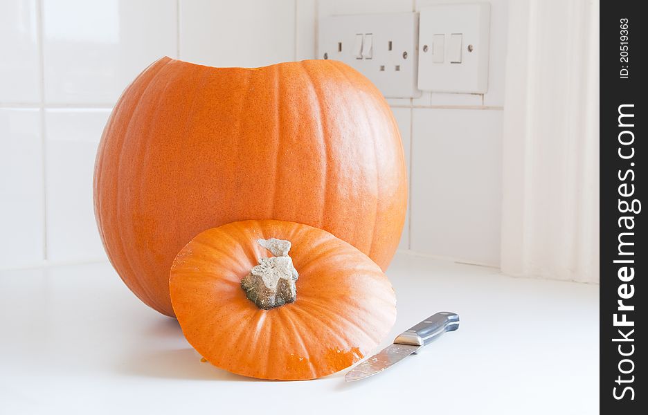 Preparing Halloween, a pumpkin and a knife in a kitchen. Preparing Halloween, a pumpkin and a knife in a kitchen