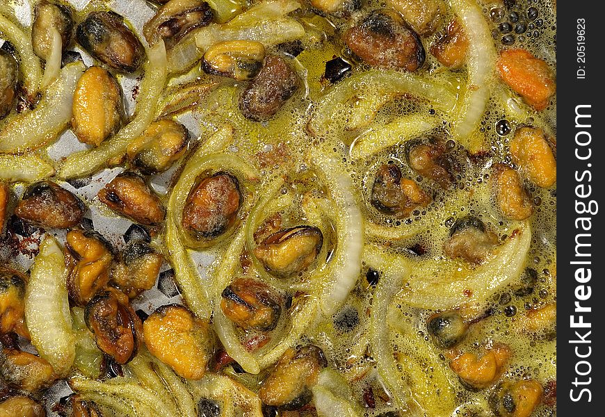 Mussels frying in pan.Background.