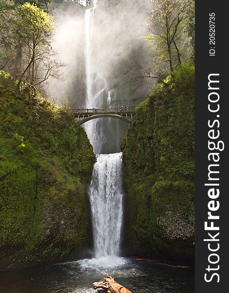 Multnomah waterfalls in Oregon with the light showcasing the mist in the air. Multnomah waterfalls in Oregon with the light showcasing the mist in the air