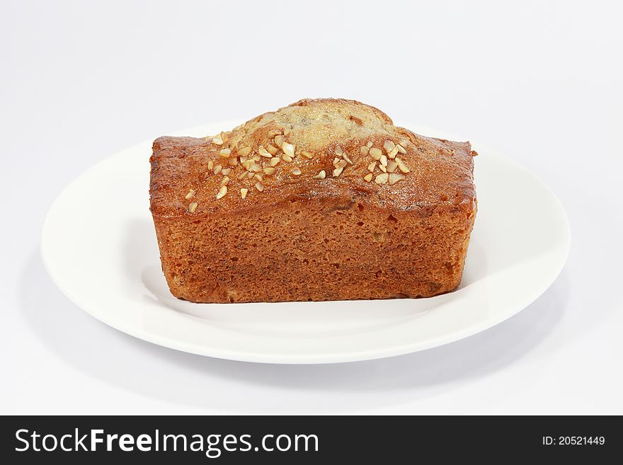 One brown and yellow loaf of fresh banana bread over white. One brown and yellow loaf of fresh banana bread over white