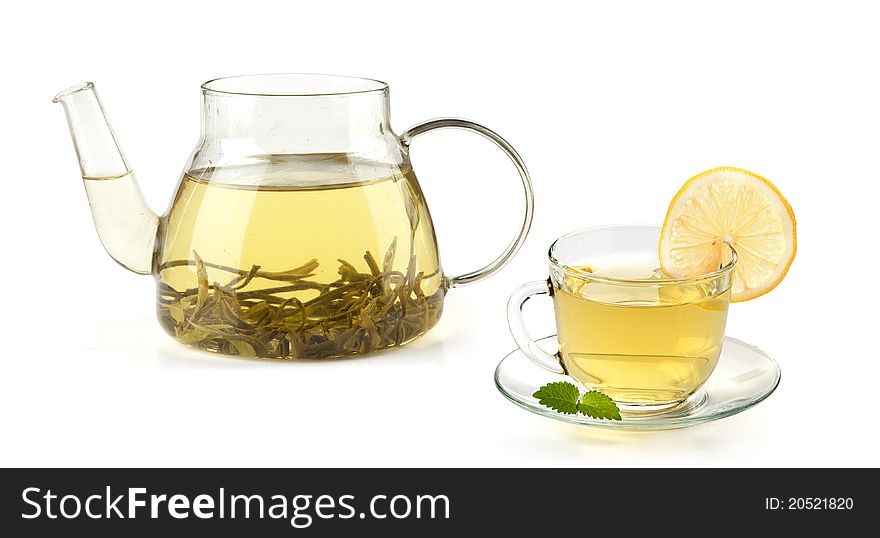 Tea in cup with leaf mint and lemon isolated on white background