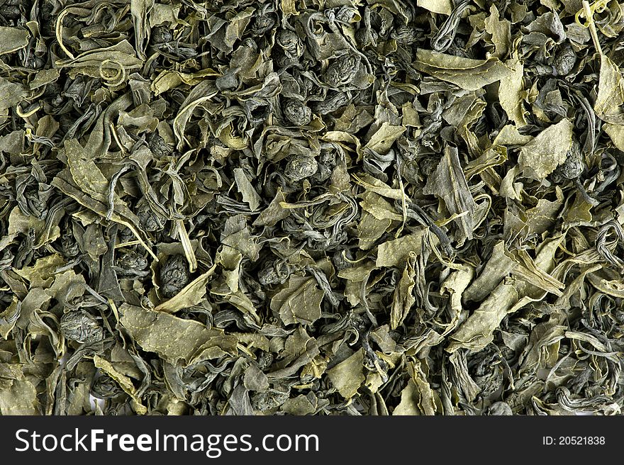 Dry green tea leaves background. Dry green tea leaves background