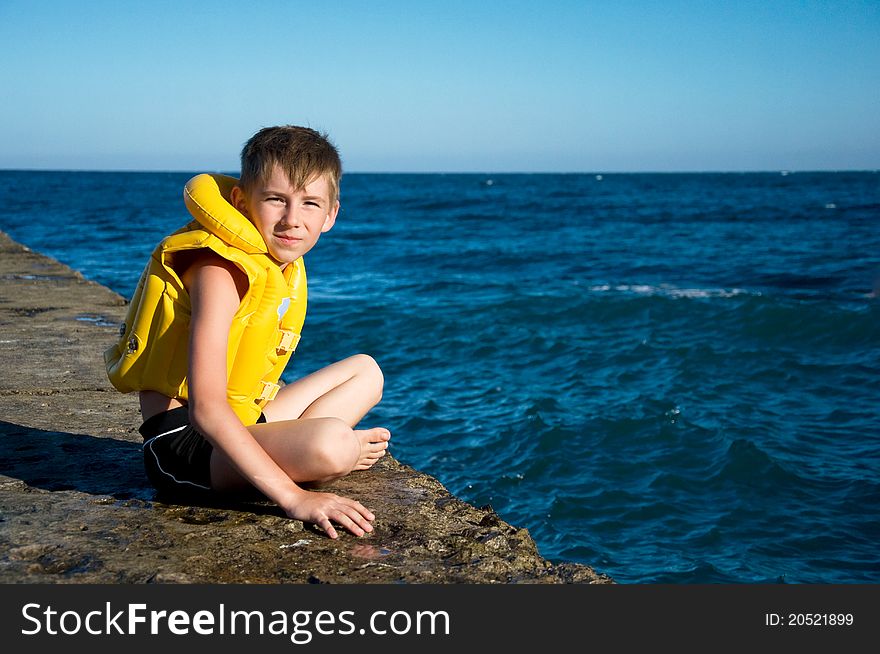 Boy in yellow life jacket