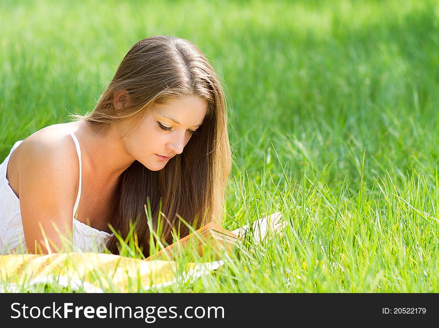 Young beautiful girl with book in nature. Young beautiful girl with book in nature