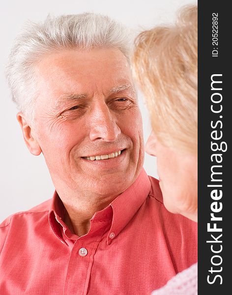 Cute elderly couple smiling on a white